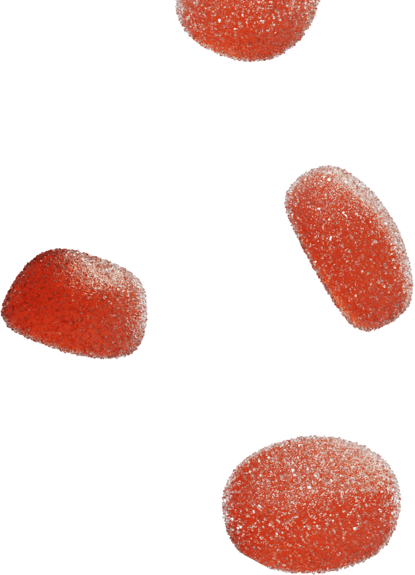 Four red sugar-coated gummy candies scattered on a black background.
